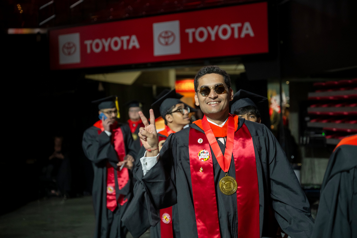 A UMD alum proudly celebrates at Commencement 2025