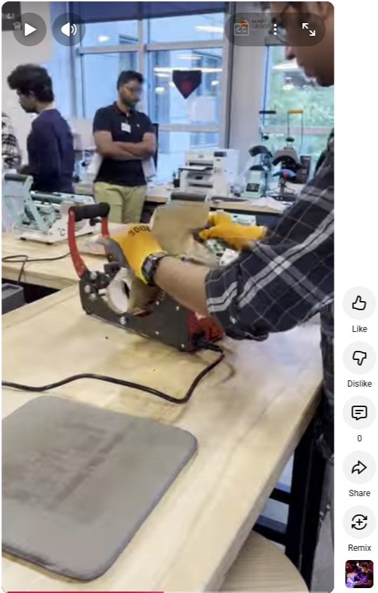 A video still from a Youtube Short. A student works with a piece of machinery in the Microsoft AR3 Garage.