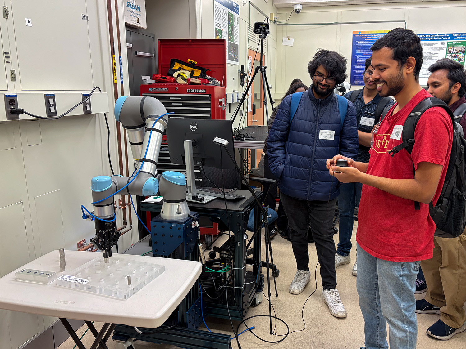 A student tries out a piece of equipment in the NIST Robotics and Automation Lab