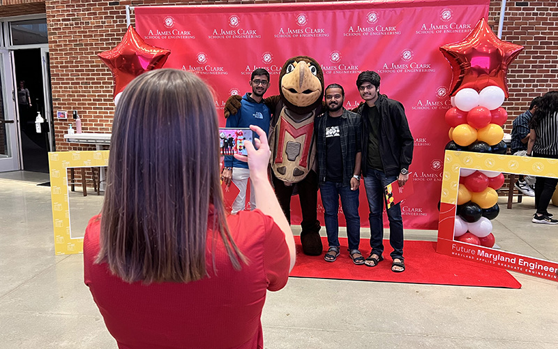 A MAGE staff member snaps a photo of students during orientation