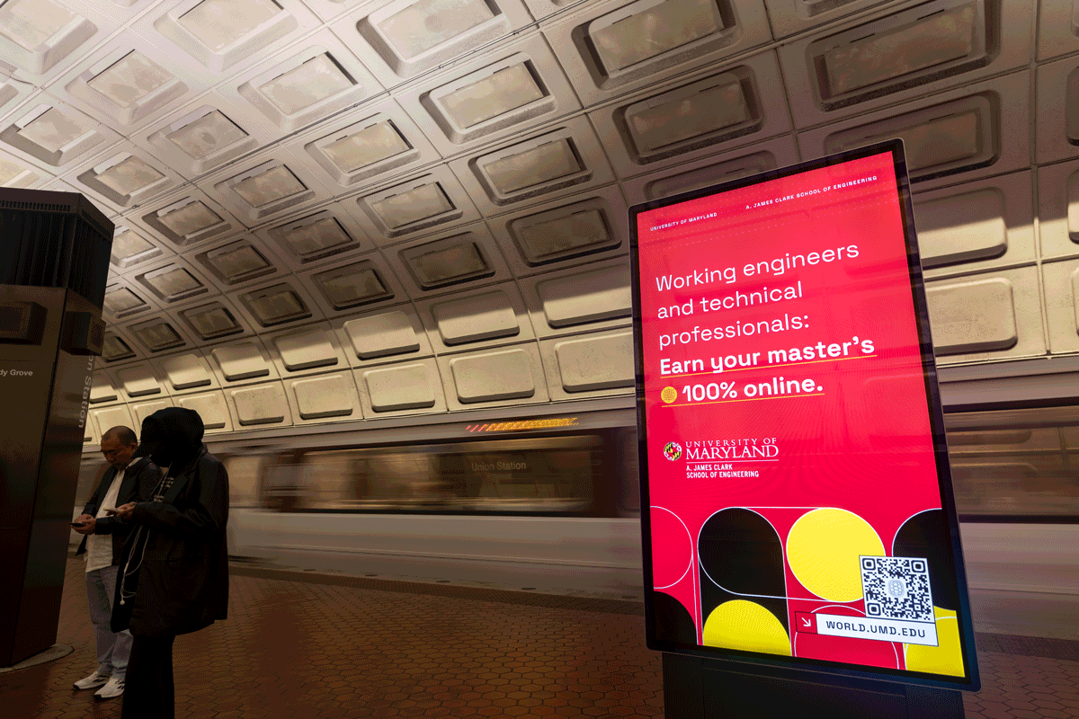 A Maryland Engineering advertisement displays on a digital screen inside Union Station as a Metrorail car speeds by in the background. a 