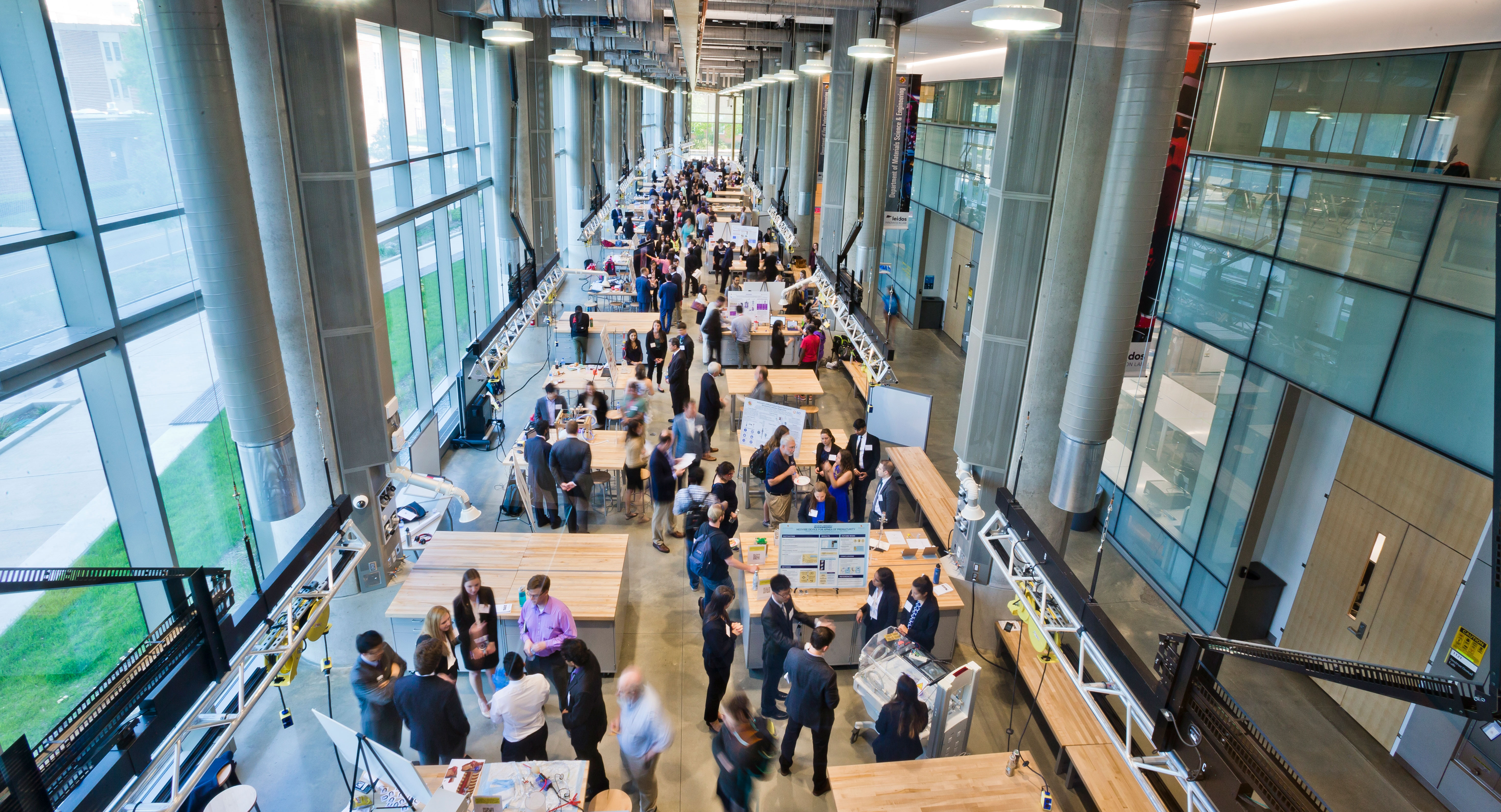 Photo of interior of Clark Hall with students gathering around multiple tables