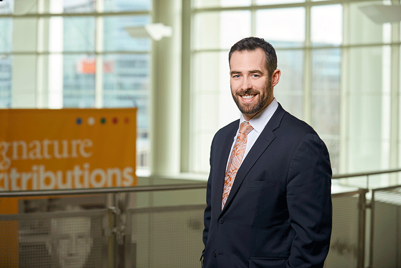Professional photo of man in front of sign