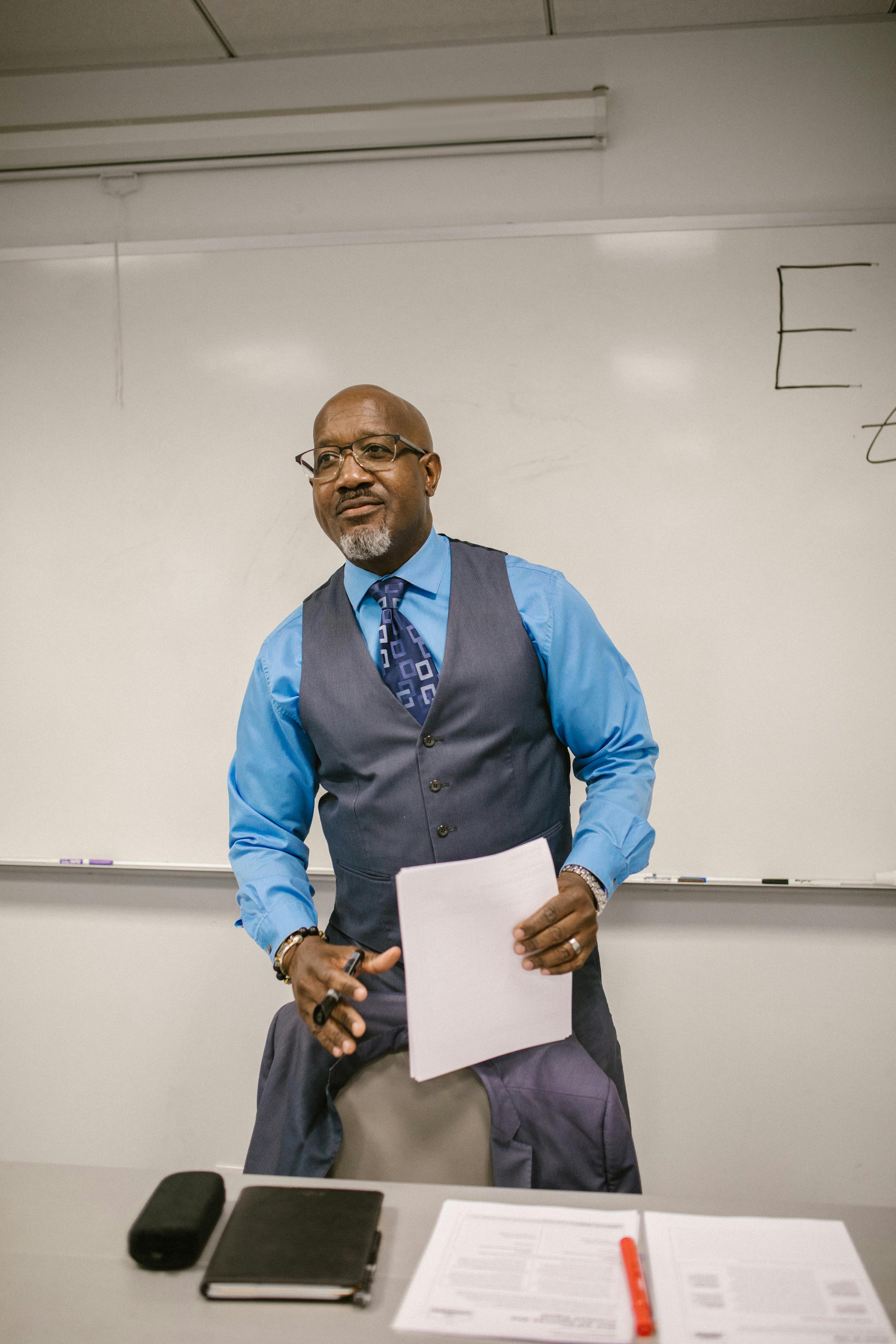 A professor stands at the front of the classroom