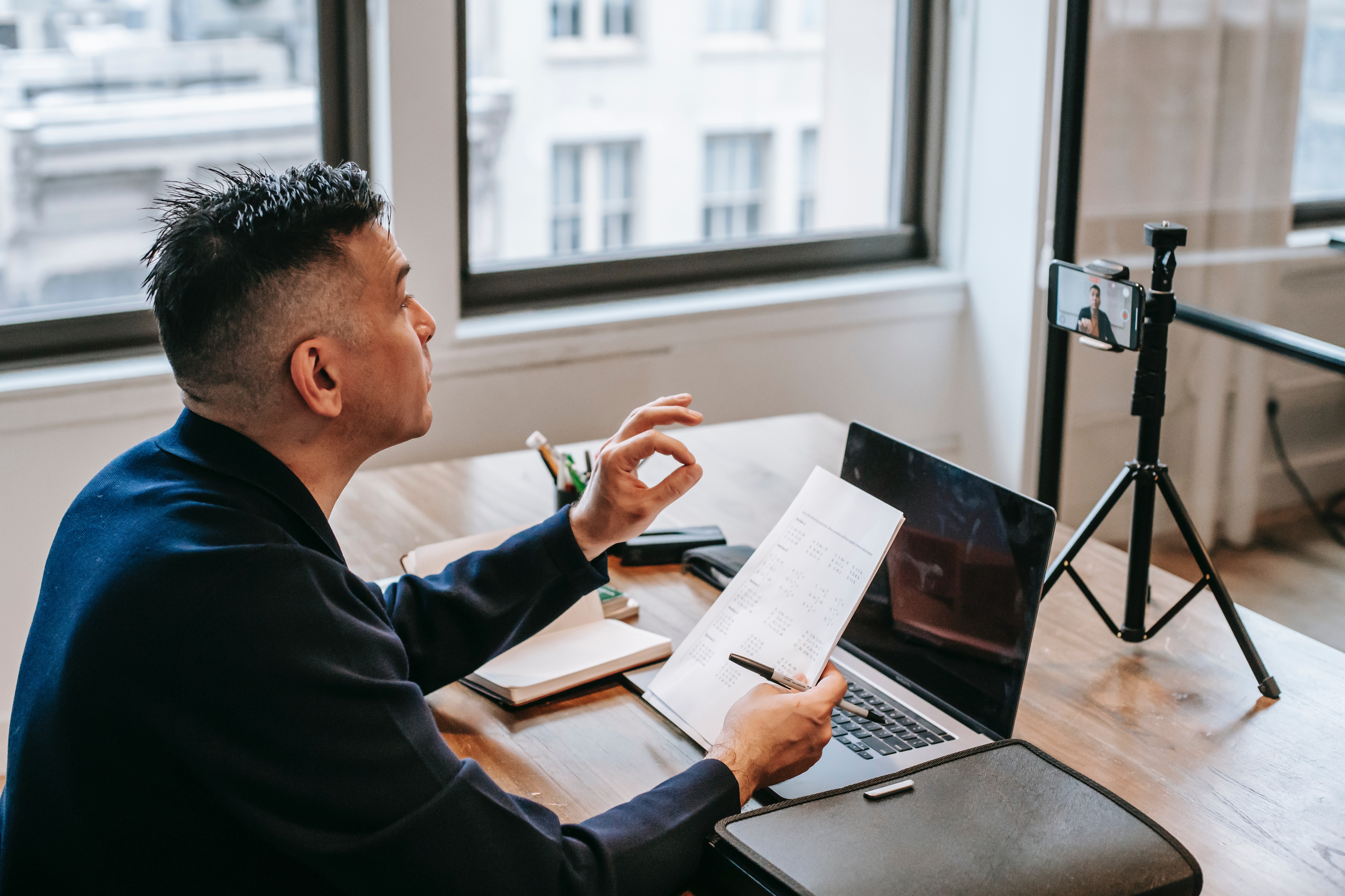 Person working on laptop while recording a talk.